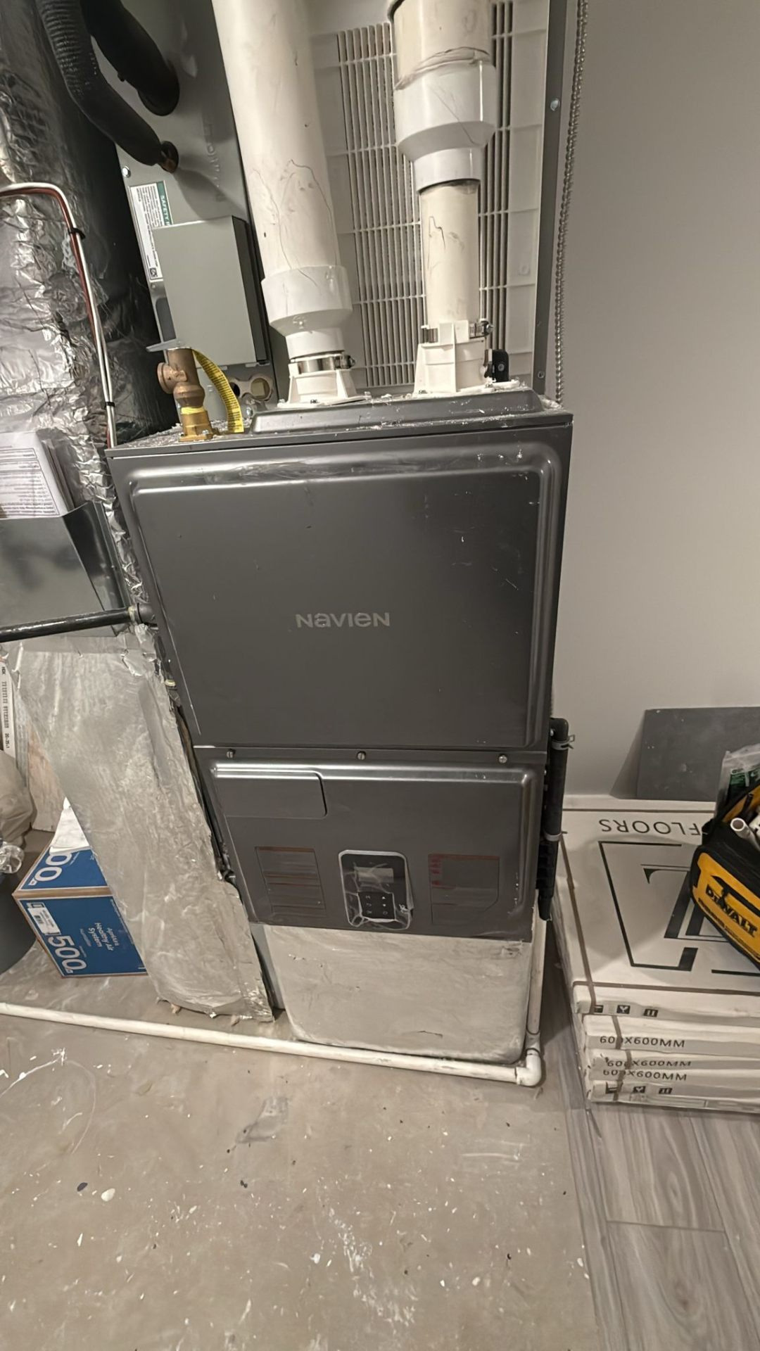 Navien 100k modulating hydro furnace installed in Edmonton Windermere custom home mechanical room.